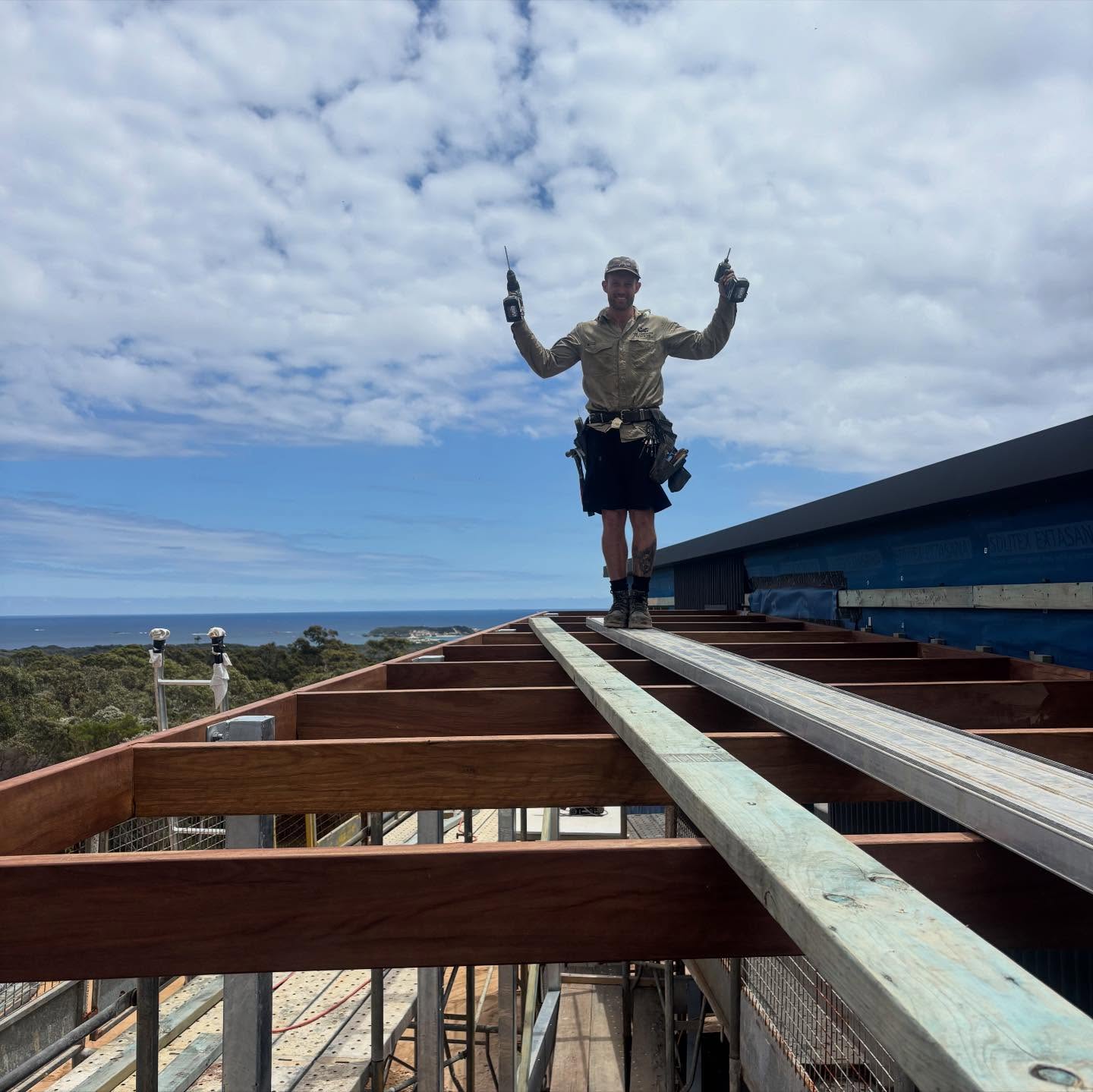 Structural carpentry underway on an elevated build with ocean views.